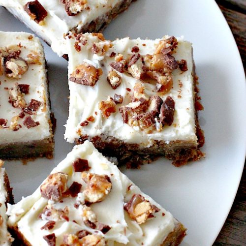 Snickers Blondies with Vanilla Buttercream Frosting