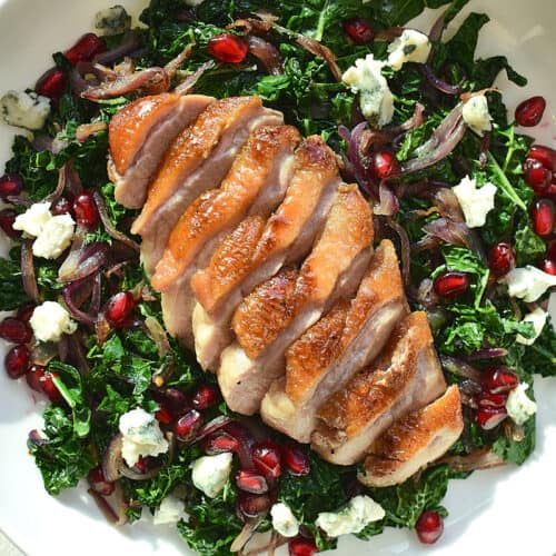 Seared Pomegranate Duck Over Wilted Greens with Roquefort