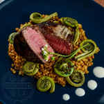 Beef Tenderloin with Einkorn, Fiddleheads, and Horseradish Cream